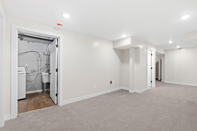 finished below grade area with carpet floors, washer / clothes dryer, baseboards, and recessed lighting