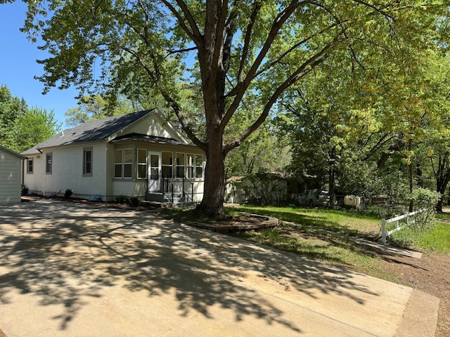 view of front of house with concrete driveway and covered porch