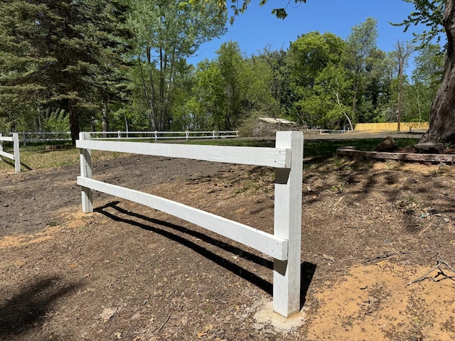gate featuring fence and a view of trees