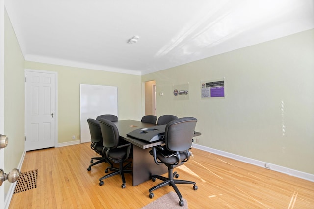 home office featuring visible vents, baseboards, and wood finished floors