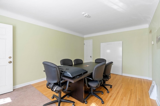 office with baseboards and light wood-style flooring