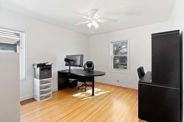 office area featuring light wood-style floors, baseboards, and a ceiling fan