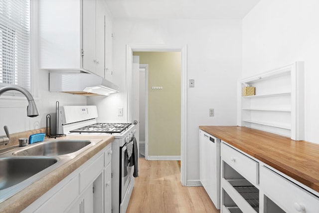 kitchen featuring light wood-type flooring, a sink, white cabinetry, and white range with gas stovetop