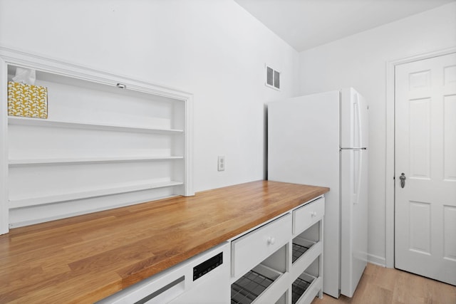 unfurnished office with light wood-type flooring and visible vents