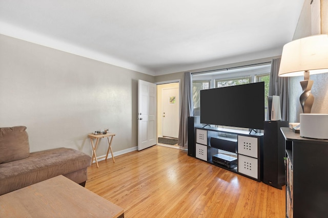 living room with baseboards and light wood finished floors