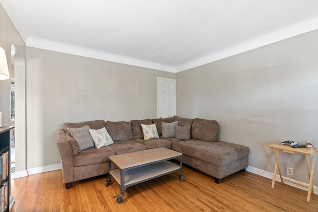 living room with baseboards and light wood-type flooring