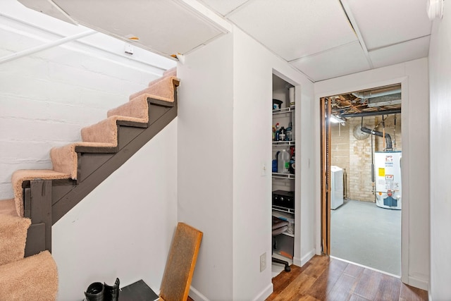 interior space featuring washer / clothes dryer, wood finished floors, and gas water heater