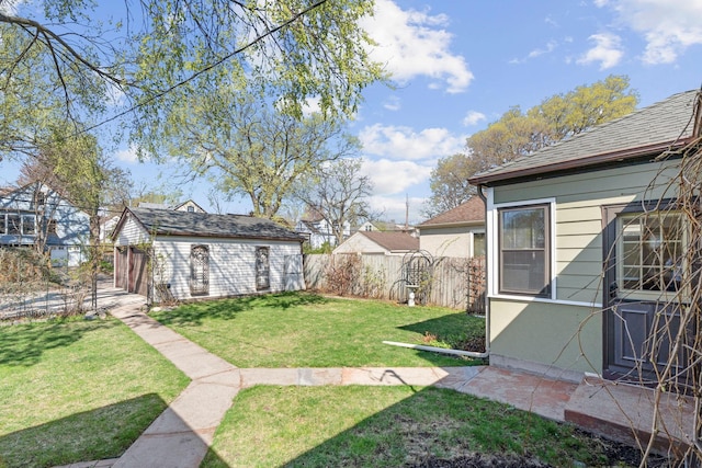 view of yard with fence and an outdoor structure