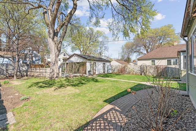 view of yard featuring a fenced backyard and an outbuilding