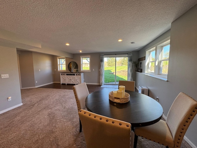 dining area featuring recessed lighting, baseboards, a healthy amount of sunlight, and dark carpet