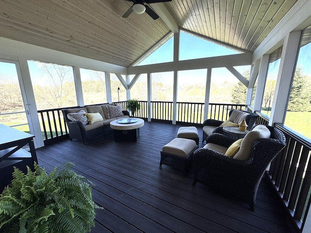 sunroom featuring an outdoor hangout area, a ceiling fan, and beamed ceiling