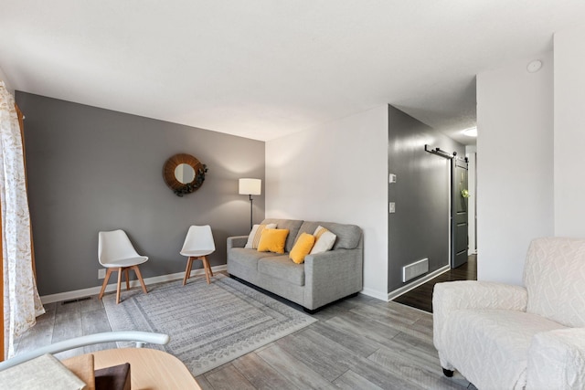 421 Robert St S, Saint Paul, MN 55107 - living room with visible vents, wood finished floors, a barn door, and baseboards