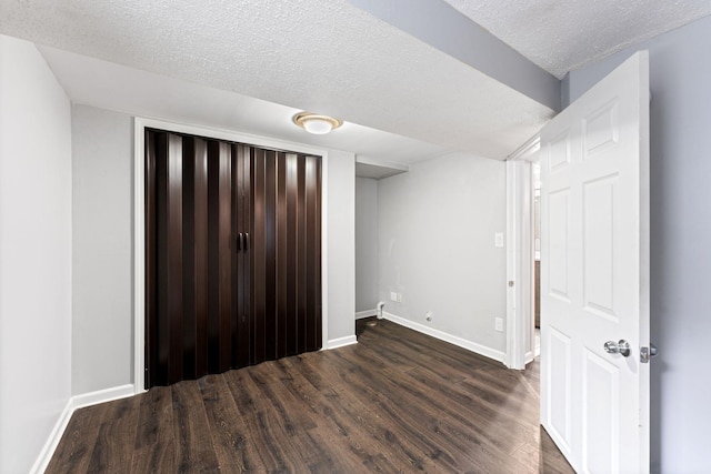 421 Robert St S, Saint Paul, MN 55107 - unfurnished bedroom with dark wood-style flooring, a textured ceiling, and baseboards