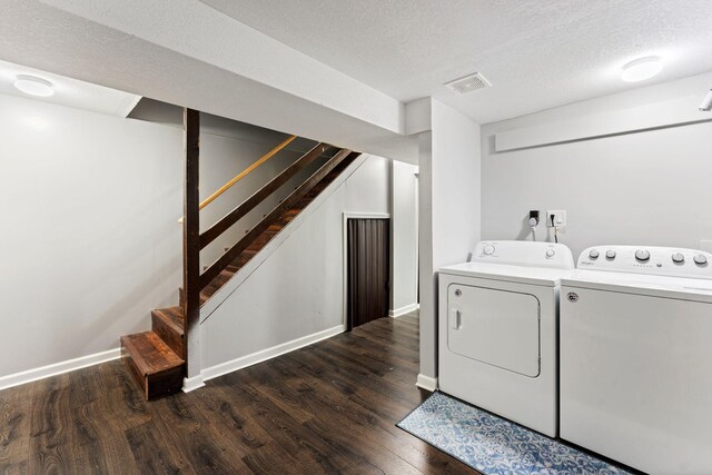 421 Robert St S, Saint Paul, MN 55107 - clothes washing area featuring a textured ceiling, baseboards, separate washer and dryer, dark wood-type flooring, and laundry area