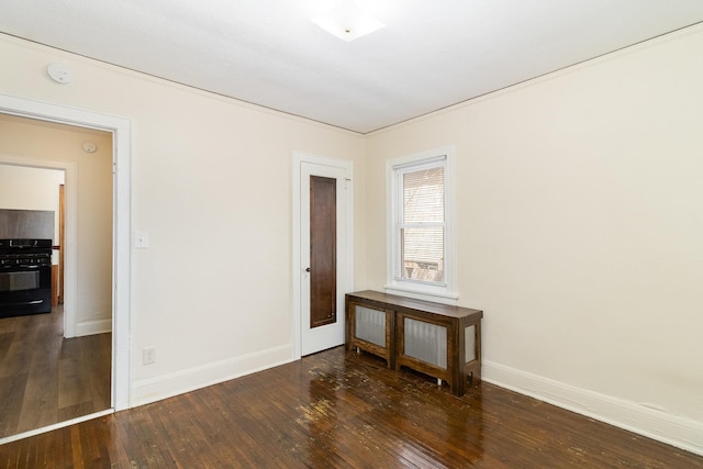 empty room with hardwood / wood-style floors and baseboards