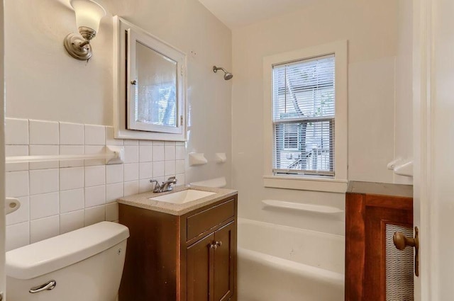 bathroom with a shower, a bathing tub, vanity, and toilet