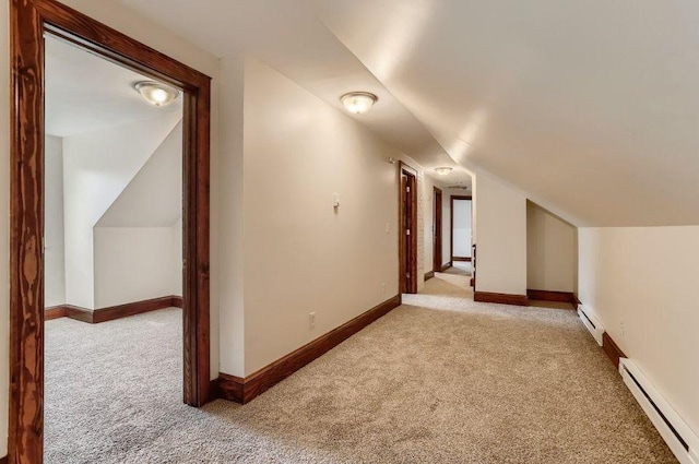 bonus room with lofted ceiling, light colored carpet, and baseboard heating