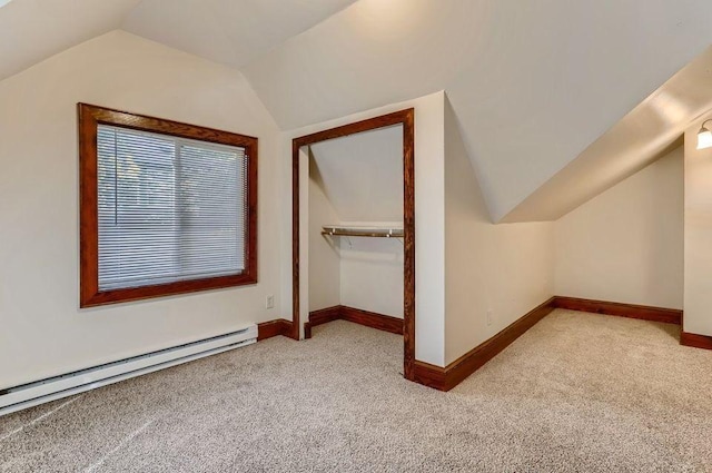 additional living space with lofted ceiling, baseboards, carpet floors, and a baseboard radiator