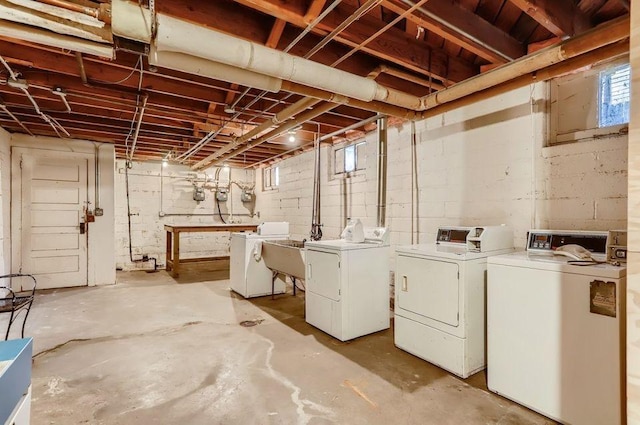 basement featuring washer and clothes dryer and a sink