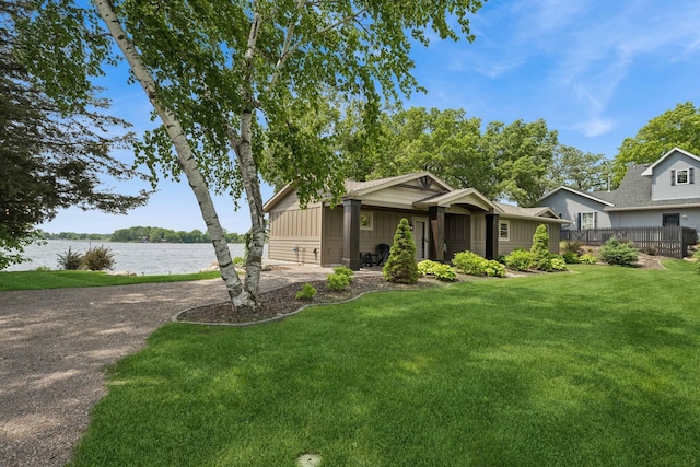 11831 Gulden Ave NW, Maple Lake, MN 55358 - view of front of house featuring a water view, a front lawn, board and batten siding, and driveway
