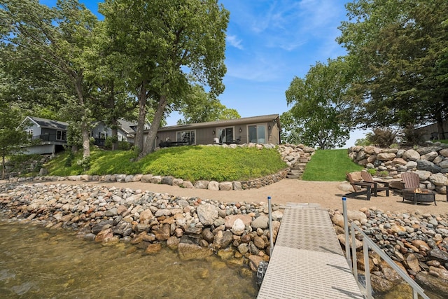 11831 Gulden Ave NW, Maple Lake, MN 55358 - back of house with a fire pit and a lawn