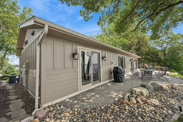 11831 Gulden Ave NW, Maple Lake, MN 55358 - rear view of house with board and batten siding and a patio