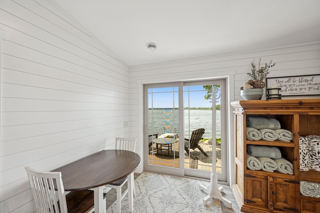 11831 Gulden Ave NW, Maple Lake, MN 55358 - dining space featuring a water view, lofted ceiling, and wood walls