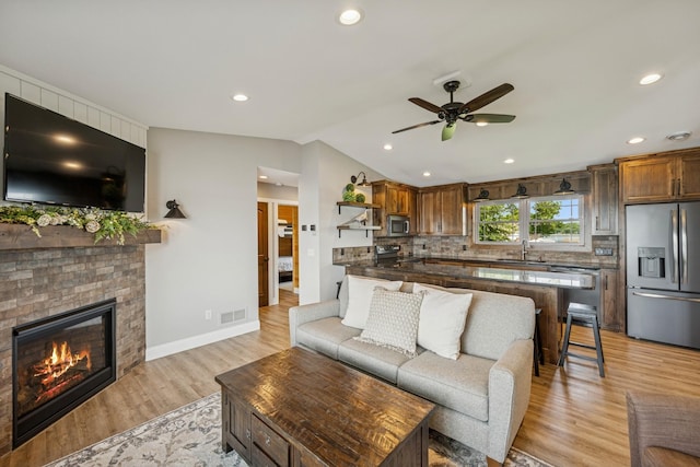 11831 Gulden Ave NW, Maple Lake, MN 55358 - living room with ceiling fan, light wood-style floors, recessed lighting, a fireplace, and vaulted ceiling