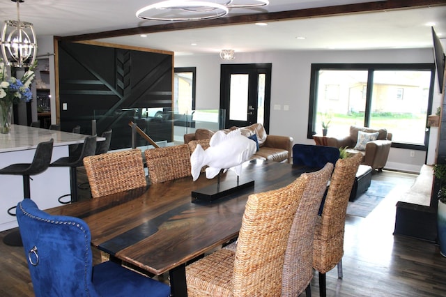 dining space featuring a chandelier, wood finished floors, beamed ceiling, and recessed lighting