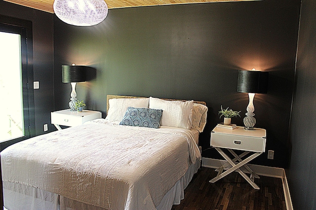 bedroom with wood finished floors and baseboards
