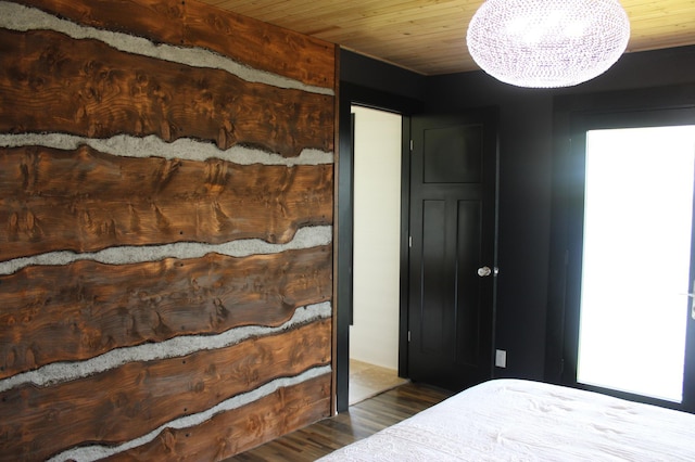 bedroom featuring wood finished floors, a chandelier, and wood ceiling
