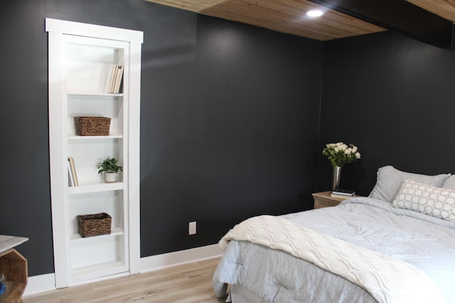 bedroom featuring baseboards and light wood-style floors