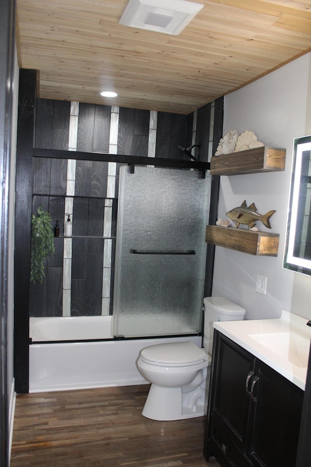 bathroom featuring wood ceiling, toilet, vanity, wood finished floors, and bath / shower combo with glass door