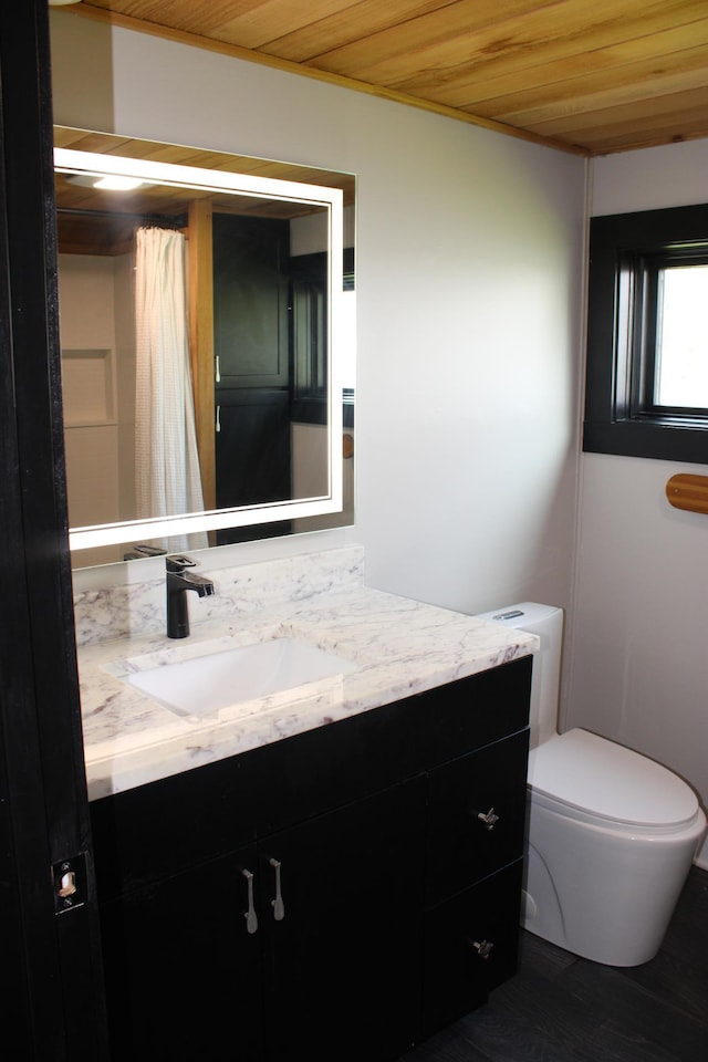full bath featuring wood ceiling, vanity, and toilet