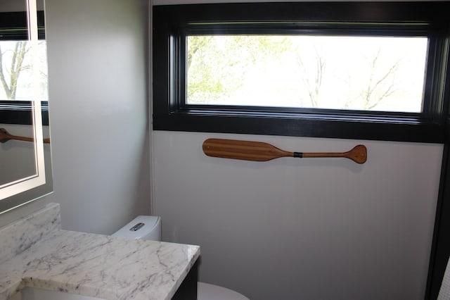 half bath featuring toilet and vanity