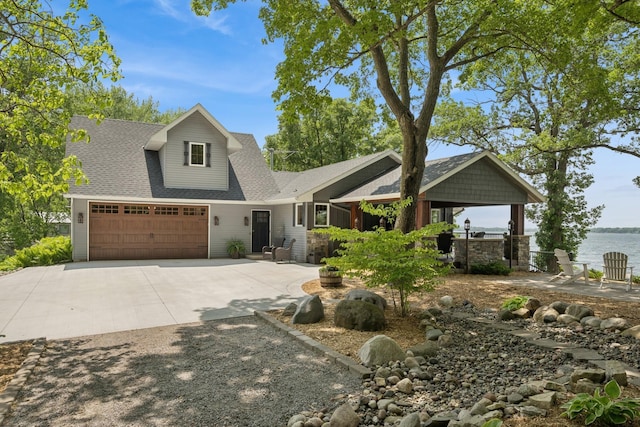 11847 Gulden Ave NW, Maple Lake, MN 55358 - craftsman-style home featuring driveway, a shingled roof, a water view, and an attached garage