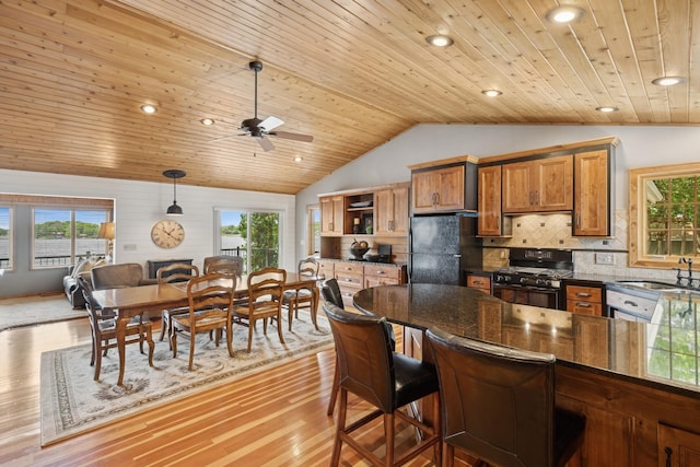 11847 Gulden Ave NW, Maple Lake, MN 55358 - kitchen with black appliances, vaulted ceiling, wooden ceiling, healthy amount of natural light, and brown cabinets