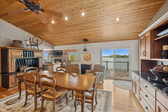 11847 Gulden Ave NW, Maple Lake, MN 55358 - dining space with wood ceiling, a stone fireplace, vaulted ceiling, light wood-style flooring, and ceiling fan