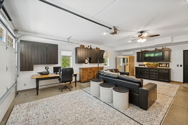 11847 Gulden Ave NW, Maple Lake, MN 55358 - living room with a textured ceiling, a wall mounted AC, a desk, and ceiling fan