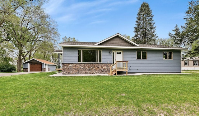 423 State St E, Grey Eagle, MN 56336 - ranch-style home featuring a front lawn, an outbuilding, stone siding, and a garage