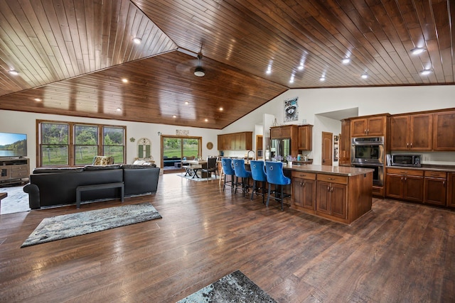 1116 County Road 46, Clearwater, MN 55320 - kitchen with open floor plan, stainless steel appliances, a kitchen island with sink, brown cabinetry, and wooden ceiling
