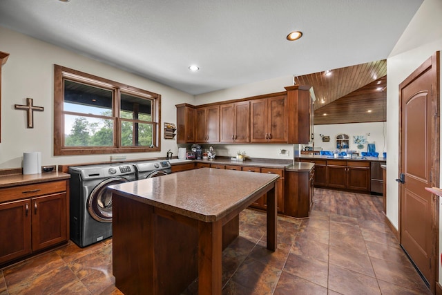 1116 County Road 46, Clearwater, MN 55320 - kitchen with washer and clothes dryer, a center island, dark countertops, stainless steel dishwasher, and recessed lighting