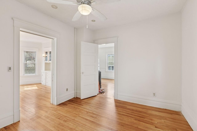 650 Pierce St NE, Minneapolis, MN 55413 - unfurnished bedroom with baseboards, a ceiling fan, and light wood finished floors