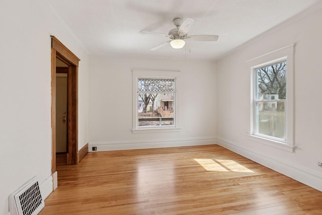 650 Pierce St NE, Minneapolis, MN 55413 - spare room with baseboards, ceiling fan, light wood finished floors, and visible vents