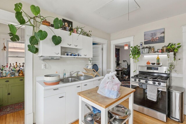 650 Pierce St NE, Minneapolis, MN 55413 - kitchen with white cabinets, open shelves, a sink, light countertops, and gas range