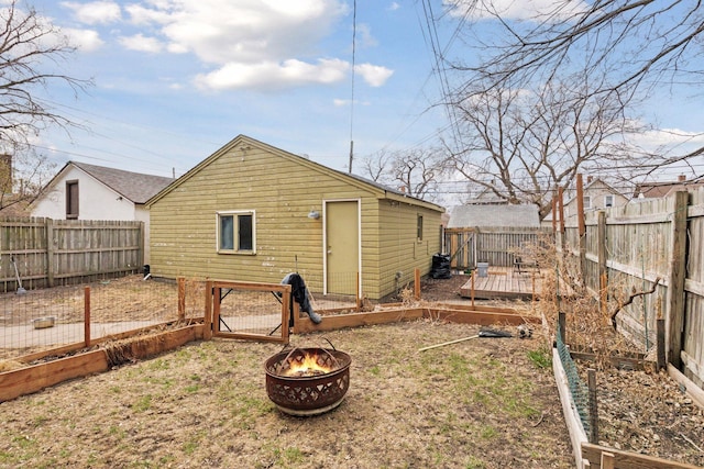 650 Pierce St NE, Minneapolis, MN 55413 - back of house with a fenced backyard, a fire pit, and a deck