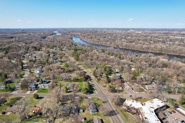 birds eye view of property with a water view and a forest view