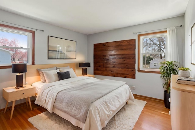 bedroom featuring baseboards and light wood-type flooring