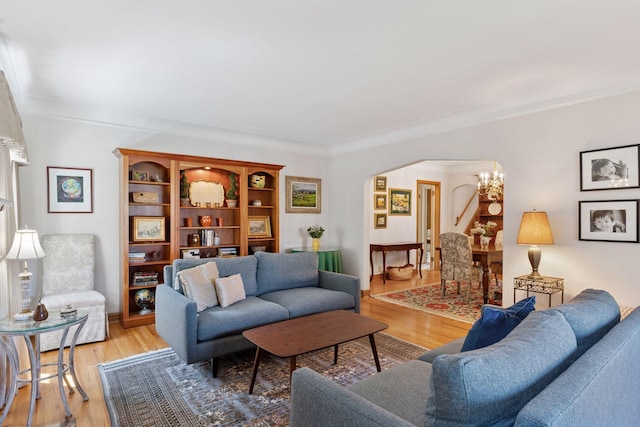 1804 Pinehurst Ave, Saint Paul, MN 55116 - living area featuring arched walkways, ornamental molding, light wood-style floors, and a chandelier