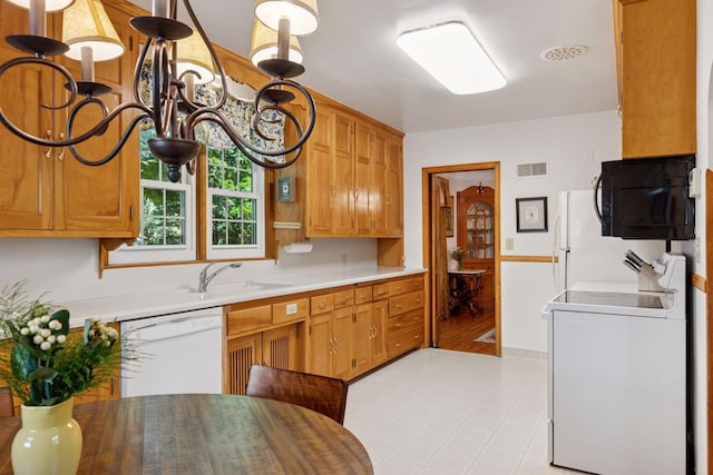 1804 Pinehurst Ave, Saint Paul, MN 55116 - kitchen featuring white appliances, light countertops, and brown cabinets